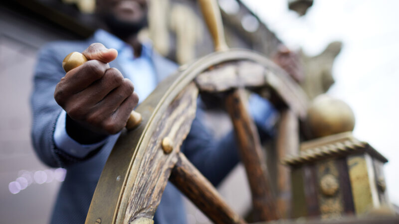 Branding by Committee: The Fastest Way to Kill Your Identity. Man steering a ship